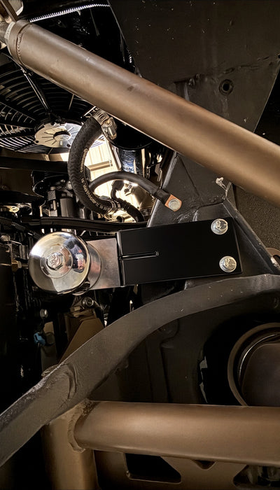 Oil relocation bracket installed on the driver side of a 1961-1969 Lincoln Continental with a Derale oil filter relocation housing